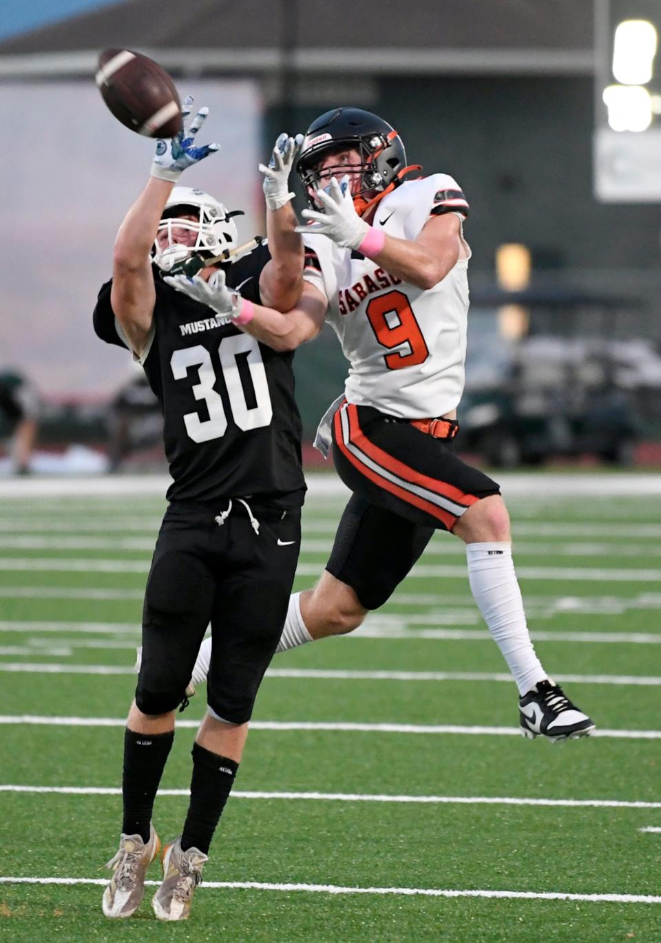 Lakewood Ranch's Caden Huffman (30) defends the Sailors' Scotty Wells (8) on Friday night.