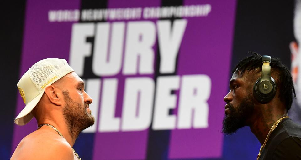 Boxers Tyson Fury (L) and Deontay Wilder (R) face off at a press conference on June 15, 2021 in Los Angeles, California to announce their third WBC heavyweight championship ficght scheduled for July 24 in las Vegas. (Photo by Frederic J. BROWN / AFP) (Photo by FREDERIC J. BROWN/AFP via Getty Images)