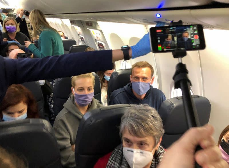 Russian opposition leader Alexei Navalny is seen on board a plane before the departure for Moscow at an airport in Berlin