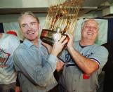 Los Angeles Dodgers manager Tommy Lasorda, right, and Fred Claire, Dodger Vice President hoist the World Series trophy following their team's decicisve 5-2 win over the Oakland A's Oct. 20,1988. (AP Photo/stf)