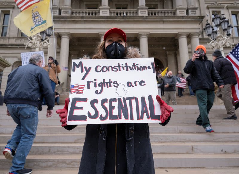 Protesters against the state's extended stay-at-home order demonstrate in Lansing