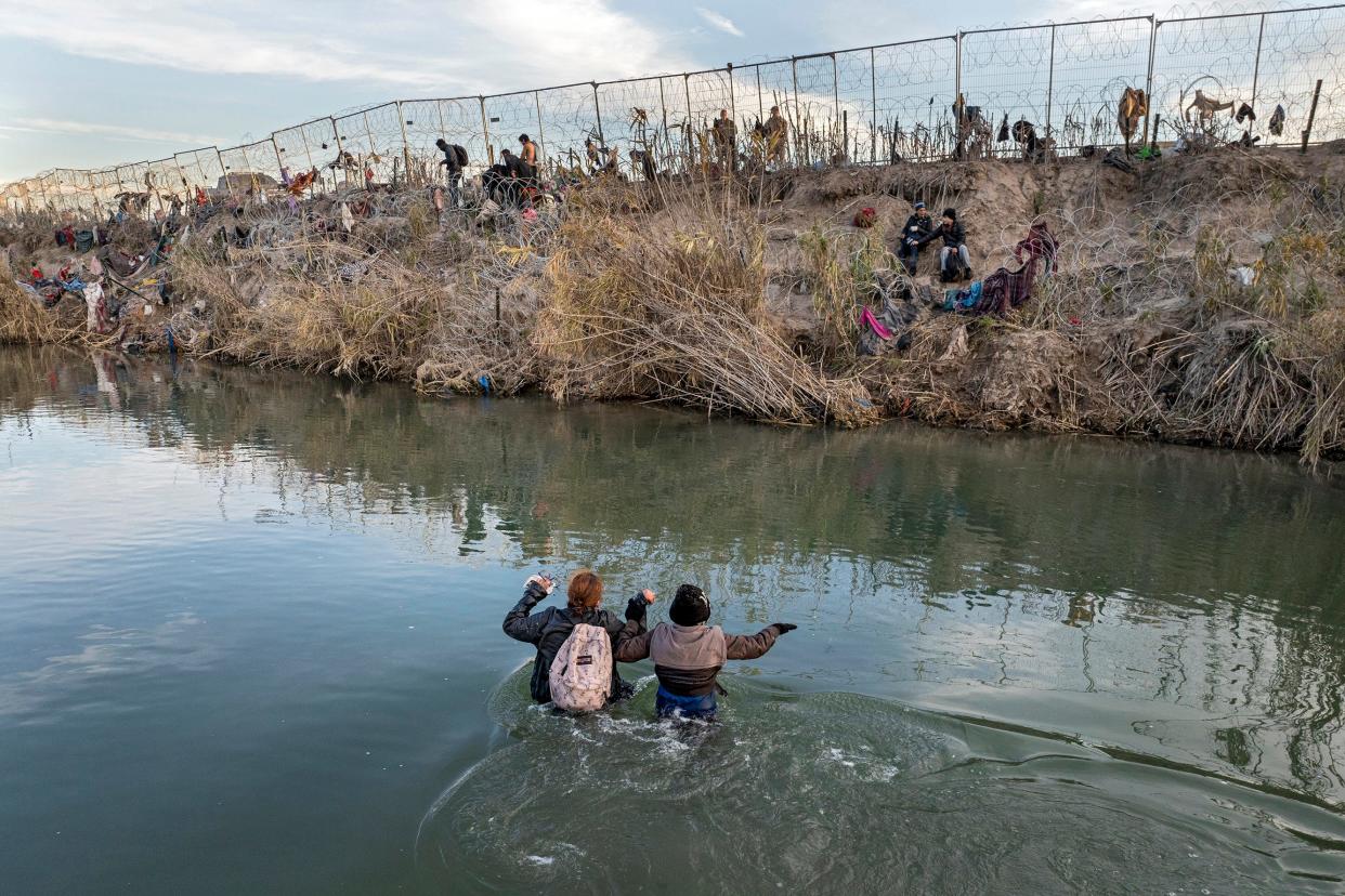 In an aerial view, immigrants wade across the Rio Grande while crossing from Mexico into the United States in Texas in January. Oklahoma legislators are moving forward with a bill to give state law enforcement authority to arrest and deport undocumented immigrants.