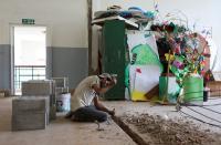 A man works inside Sagesse Beyrouth school which was damaged due to the explosion at the port area, in Beirut