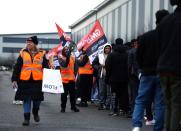 Protestors hold banners during industrial action outside the Amazon warehouse