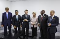 FILE - From left, US Special Presidential Envoy for Climate John Kerry, British Prime Minister Rishi Sunak, French President Emmanuel Macron, President of the European Commission Ursula von der Leyen, South African President Cyril Ramaphosa and German Chancellor Olaf Scholz meet on the sidelines of the COP27 climate summit in Sharm el-Sheikh, Egypt, Nov. 7, 2022. In his first month as Britain's prime minister, Rishi Sunak has stabilized the economy, reassured allies from Washington to Kyiv and even soothed the European Union after years of sparring between Britain and the bloc. (Ludovic Marin,/Pool via AP, File)