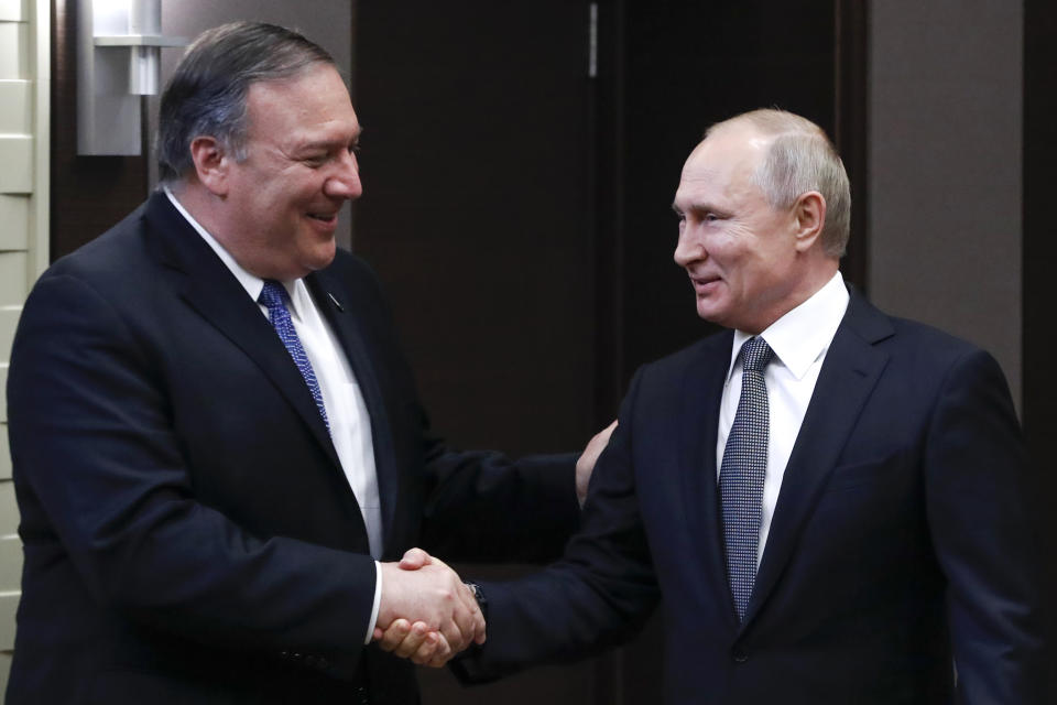 In this May 14, 2019, photo, Russian President Vladimir Putin, right, and U.S. Secretary of State Mike Pompeo, shake hands prior to their talks in the Black Sea resort city of Sochi, southern Russia. (AP Photo/Pavel Golovkin, Pool)