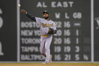 Oakland Athletics' Elvis Andrus throws to first to retire Boston Red Sox's Rafael Devers in the sixth inning of a baseball game, Thursday, May 13, 2021, in Boston. (AP Photo/Steven Senne)