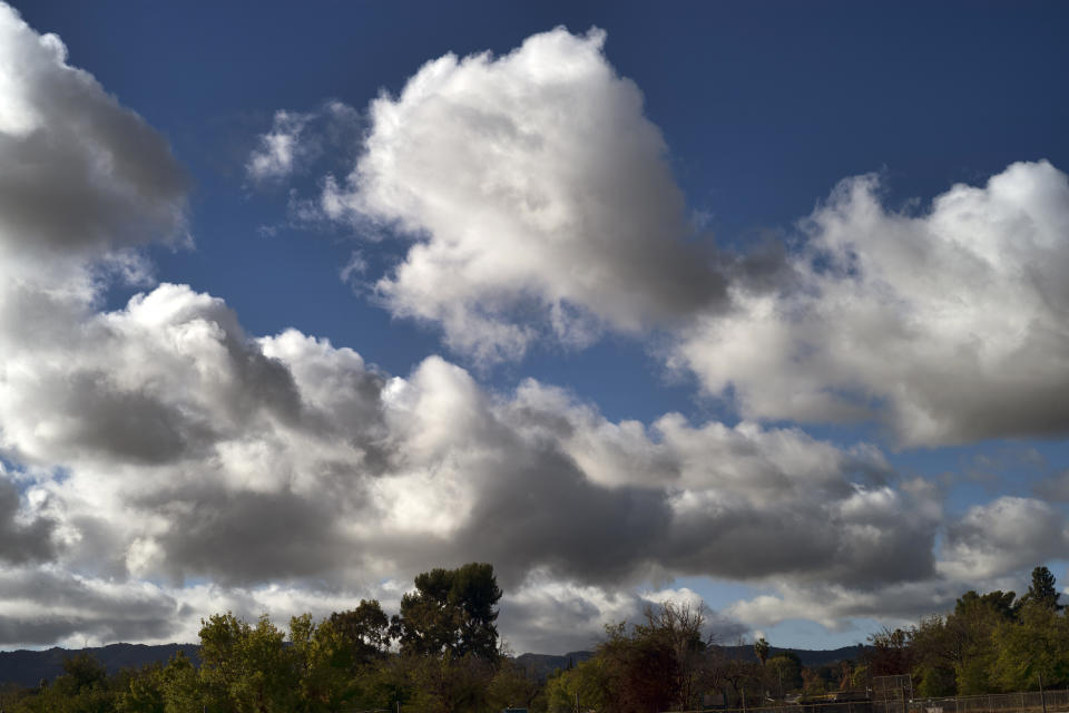 Early morning storm clouds pass over the Encino section of Los Angeles, on Wednesday, Nov. 9, 2022. A drenched California emerged Wednesday from a powerful storm that unleashed rain, snow and raging floodwaters. (AP Photo/Richard Vogel)