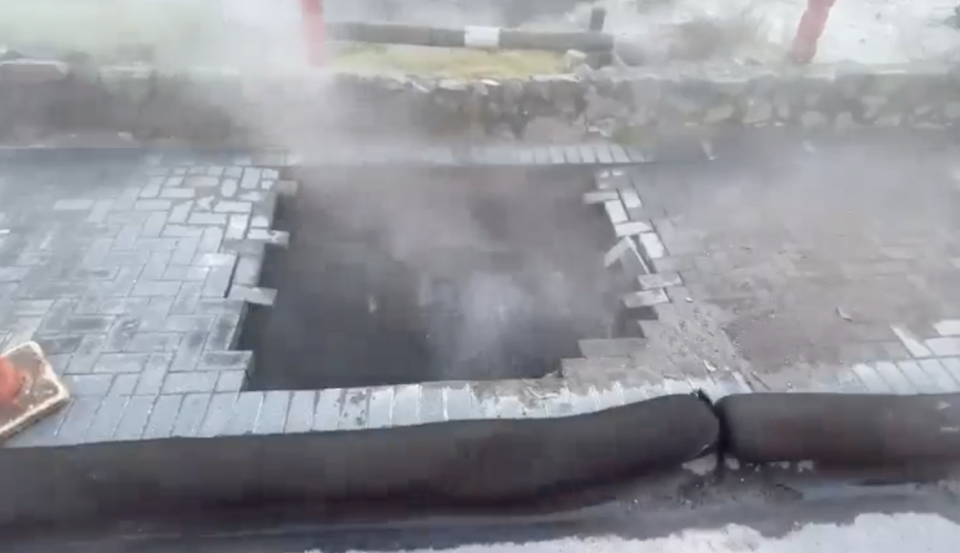 Pictured is the sink hole in Rotorua, with steam coming out and the paving caved in.