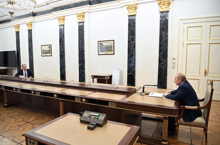 Russian President Vladimir Putin, right, meets with Russian Foreign Minister Sergey Lavrov, left, in Moscow, Russia, Monday, Feb. 14, 2022. (Alexei Nikolsky, Sputnik, Kremlin Pool Photo via AP)