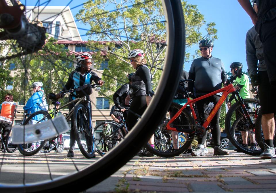 (4/20/19)Cyclists gather at Janet Leigh Plaza in downtown Stockton before a Full Moon Riders casual ride event on April 20. This an example of layering. The bike wheel in the foreground is one layer and the cyclists in the background are another.