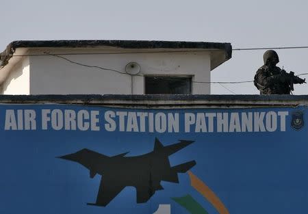 An Indian security personnel stands guard on a building at the Indian Air Force (IAF) base at Pathankot in Punjab, India, January 5, 2016. REUTERS/Mukesh Gupta/Files