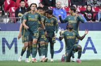 LA Galaxy's Joseph Paintsil, front right, celebrates his goal against the Vancouver Whitecaps during the second half of an MLS soccer match Saturday, April 13, 2024, in Vancouver, British Columbia. (Darryl Dyck/The Canadian Press via AP)