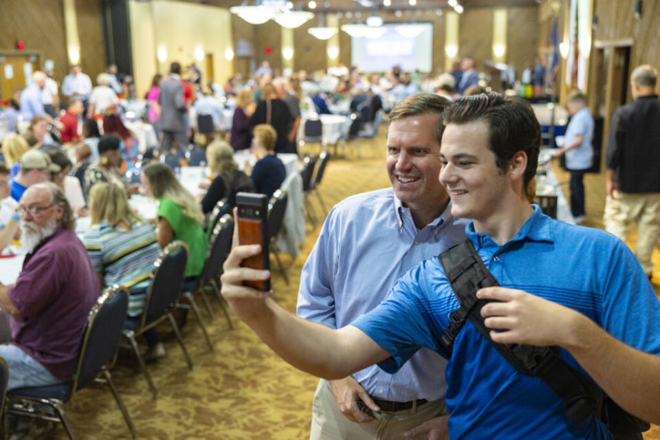  Morgan Eaves, executive director of the Kentucky Democratic Party, says Beshear appeals to younger Democrats and disillusioned voters. The governor took a photo with a supporter during the 26th annual Mike Miller Memorial Bean Dinner in Marshall County, Aug. 4, 2023. (Kentucky Lantern photo by Austin Anthony)