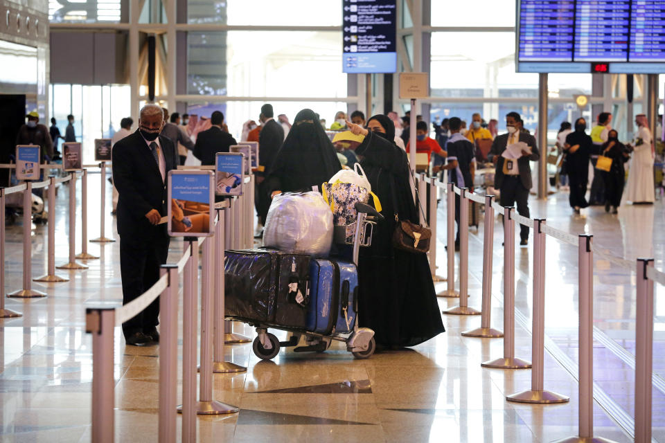 Saudi passengers enter King Abdulaziz International Airport in Jiddah, Saudi Arabia, Monday, May 17, 2021. Vaccinated Saudis will be allowed to leave the kingdom for the first time in more than a year as the country eases a ban on international travel that had been in place to try and contain the spread of the coronavirus and its new variants. (AP Photo/Amr Nabil)