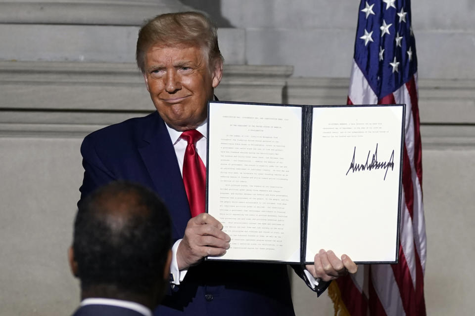 President Donald Trump holds a signed Constitution Day proclamation after he spoke to the White House conference on American History at the National Archives museum, Thursday, Sept. 17, 2020, in Washington. (AP Photo/Alex Brandon)