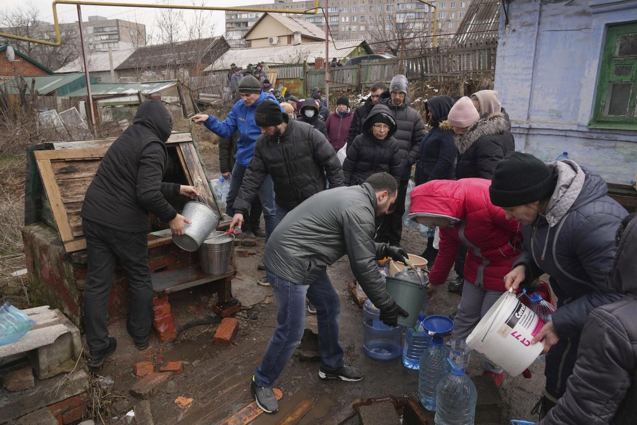 People line up to get water at the well in outskirts of Mariupol, Ukraine, Wednesday, March 9, 2022.