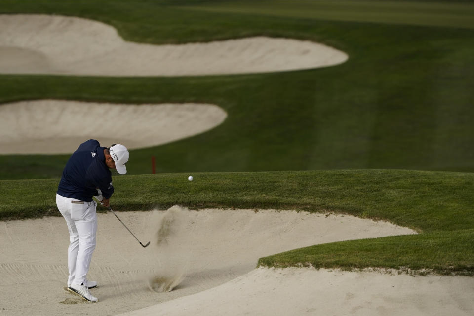 Daniel Berger hits from the bunker on the 18th hole during the second round of the PGA Championship golf tournament at TPC Harding Park Friday, Aug. 7, 2020, in San Francisco. (AP Photo/Charlie Riedel)