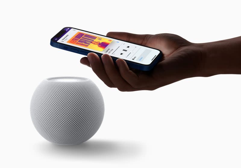 Apple's HomePod mini is seen with an iPhone in a photograph released in Cupertino