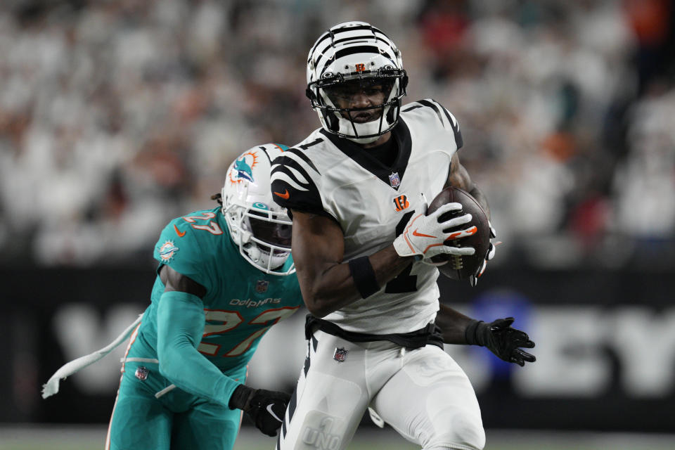 Cincinnati Bengals' Ja'Marr Chase (1) makes a catch against Miami Dolphins' Keion Crossen (27) during the second half of an NFL football game, Thursday, Sept. 29, 2022, in Cincinnati. (AP Photo/Jeff Dean)