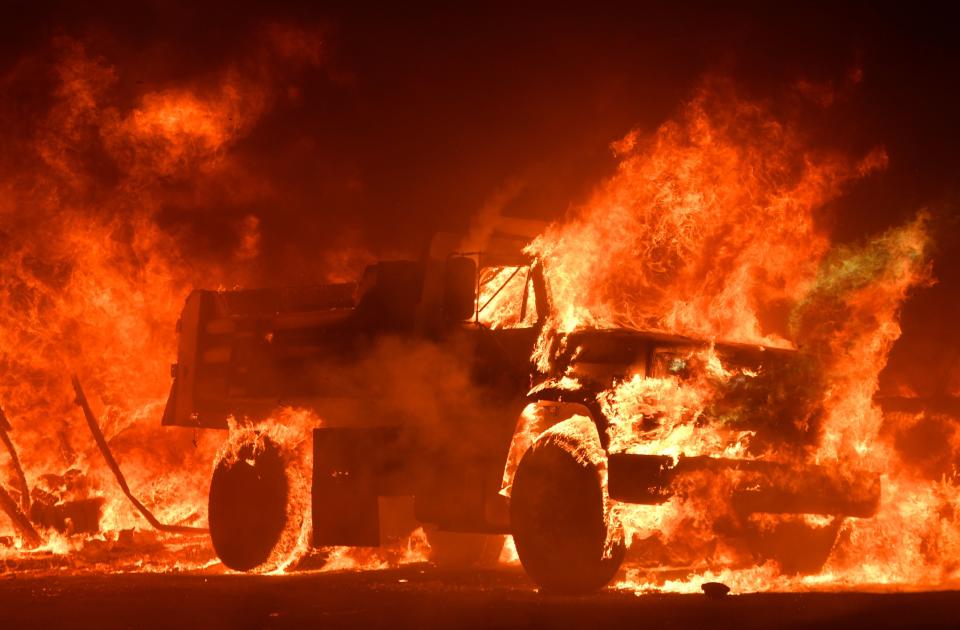 A truck is totally consumed by flames.