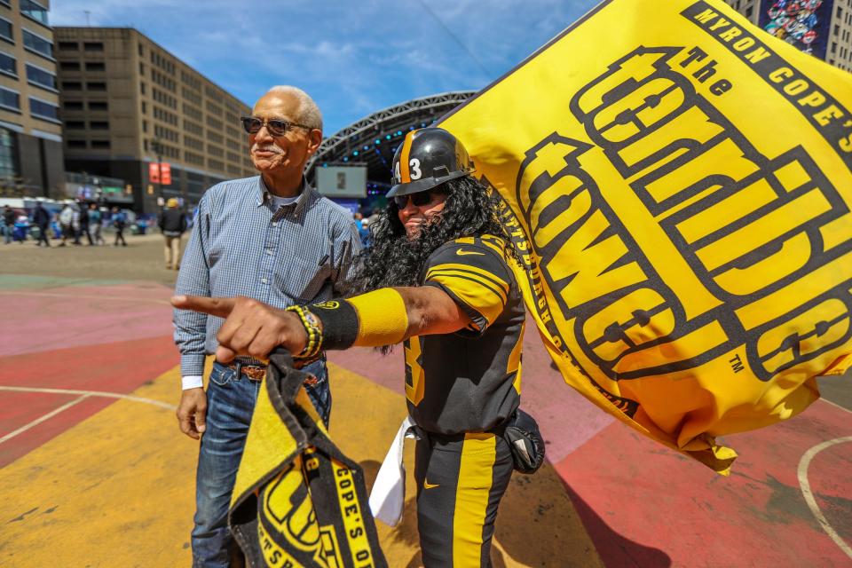 Gershwin Drain, a Detroit federal judge, gets his photo taken with Mike “Mascot Troy” Dapcevich, during the NFL Draft Experience in downtown Detroit on Friday, April 26, 2024.