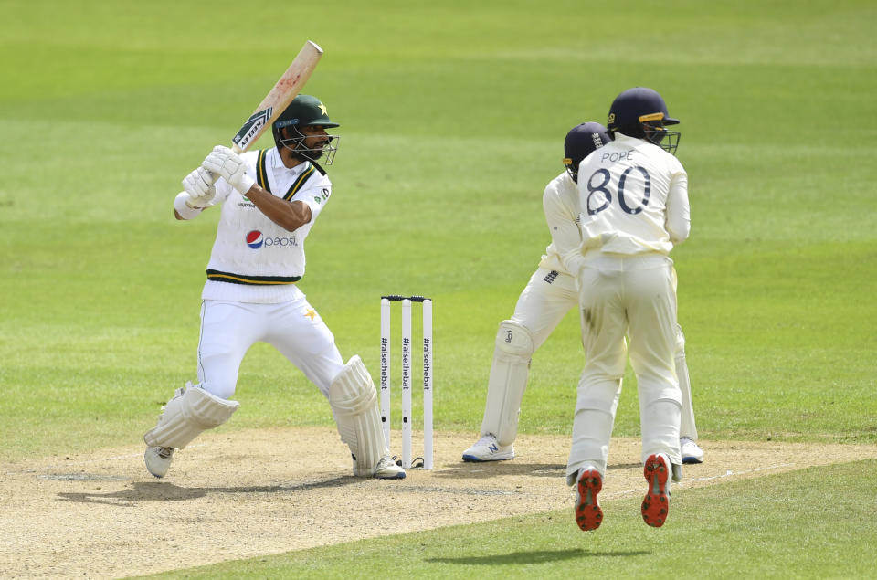 Pakistan's Shan Masood, left, bats during the second day of the first cricket Test match between England and Pakistan at Old Trafford in Manchester, England, Thursday, Aug. 6, 2020. (Dan Mullan/Pool via AP)