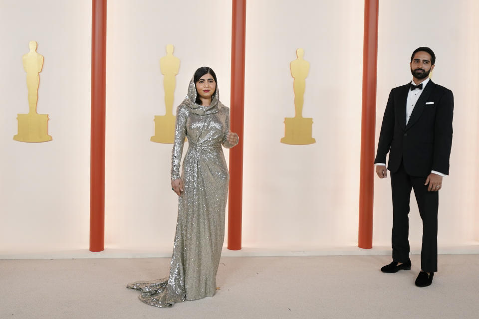 Malala Yousafzai, left, and Asser Malik arrive at the Oscars on Sunday, March 12, 2023, at the Dolby Theatre in Los Angeles. (AP Photo/Ashley Landis)