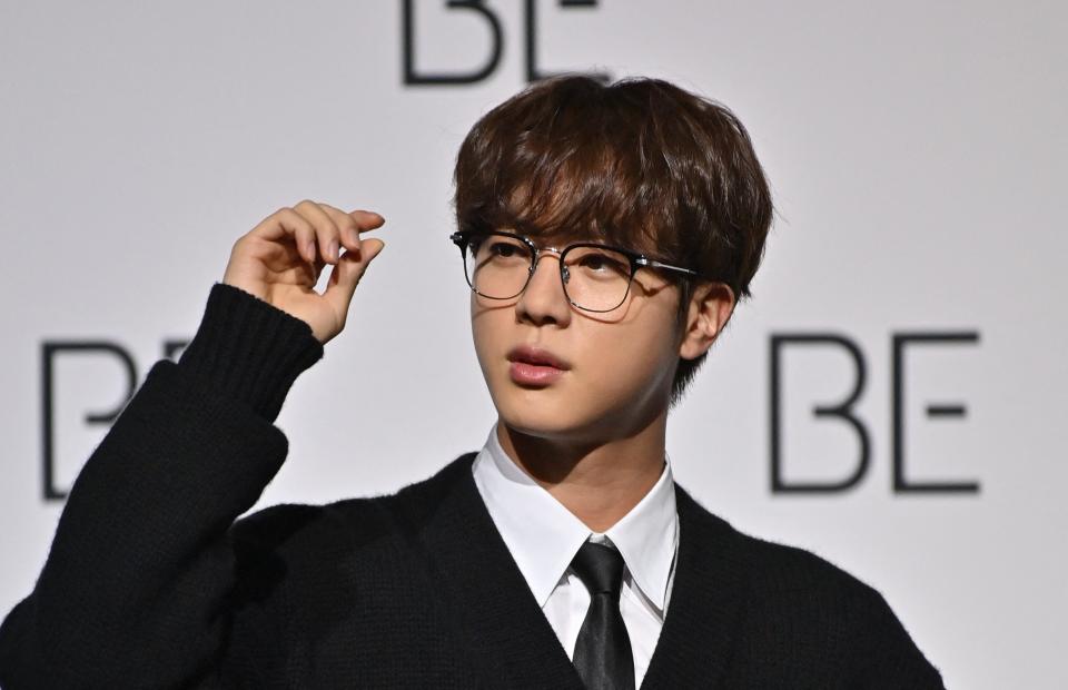 In this file photo taken on November 20, 2020 South Korean K-pop boy band BTS member Jin poses for a photo session during a press conference on BTS new album 'BE (Deluxe Edition)' in Seoul.