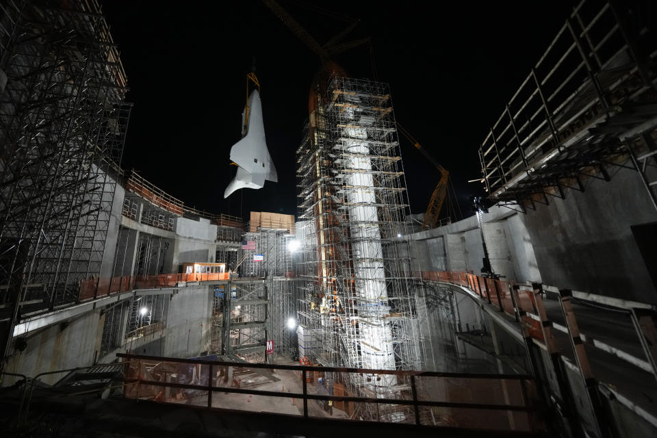 Space Shuttle Endeavour is lifted into the site of the future Samuel Oschin Air and Space Center on Tuesday, Jan. 30, 2024, in Los Angeles. (AP Photo/Ashley Landis)
