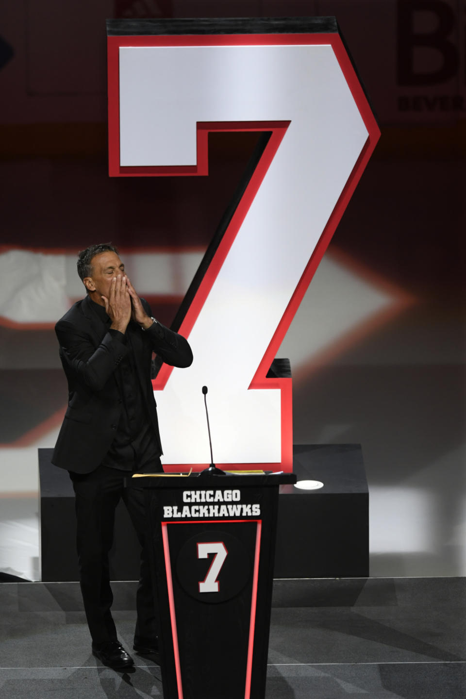 Former Chicago Blackhawks great Chris Chelios has his jersey retired during a ceremony before an NHL hockey game between the Chicago Blackhawks and Detroit Red Wings Sunday, Feb. 25, 2024, in Chicago. (AP Photo/Paul Beaty)