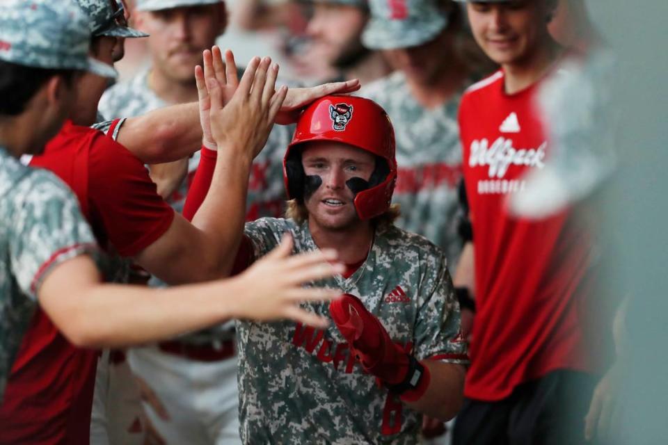 NC State’s Matt Heavner celebrates with his teammates after scoring a run during Game 3 of the Super NCAA regional at Foley Field on Monday, June 10, 2024 in Athens, Ga.