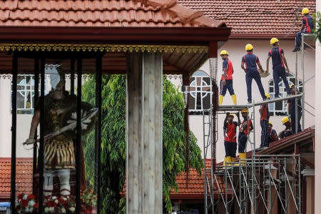 Army personnel repair St. Sebastian Church which was damaged during string of suicide bomb attacks on churches and luxury hotels across the island on Easter Sunday, in Negombo, Sri Lanka, April 30, 2019. REUTERS/Danish Siddiqui