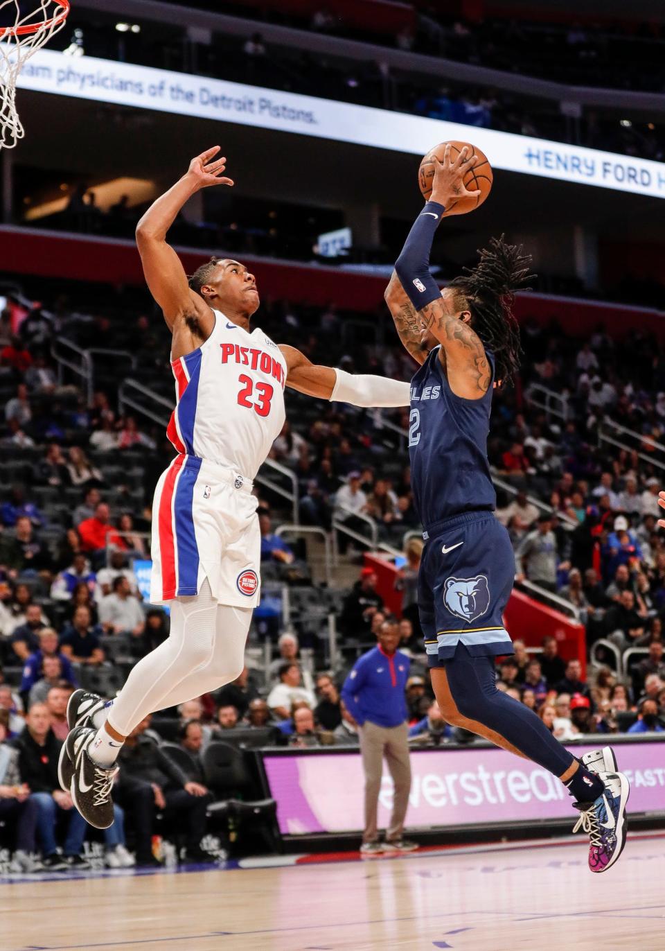Memphis Grizzlies guard Ja Morant (12) goes to the basket against Detroit Pistons guard Jaden Ivey (23) during the first half of a preseason game at Little Caesars Arena in Detroit on Thursday, Oct. 13, 2022.