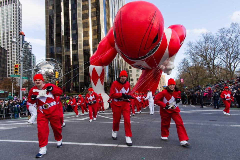 Parade Volunteers fight with winds as Power Rangers Mighty Morphin Red Ranger balloon makes its way down Columbus Circle during the Macy's Thanksgiving Day Parade, Thursday, Nov. 28, 2019, in New York. (AP Photo/Eduardo Munoz Alvarez)