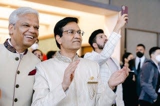 Dr. Manoj Jain (right) with close family friend Dipak Doshi (left) at the wedding ceremony unmasked after PCR tests were negative.