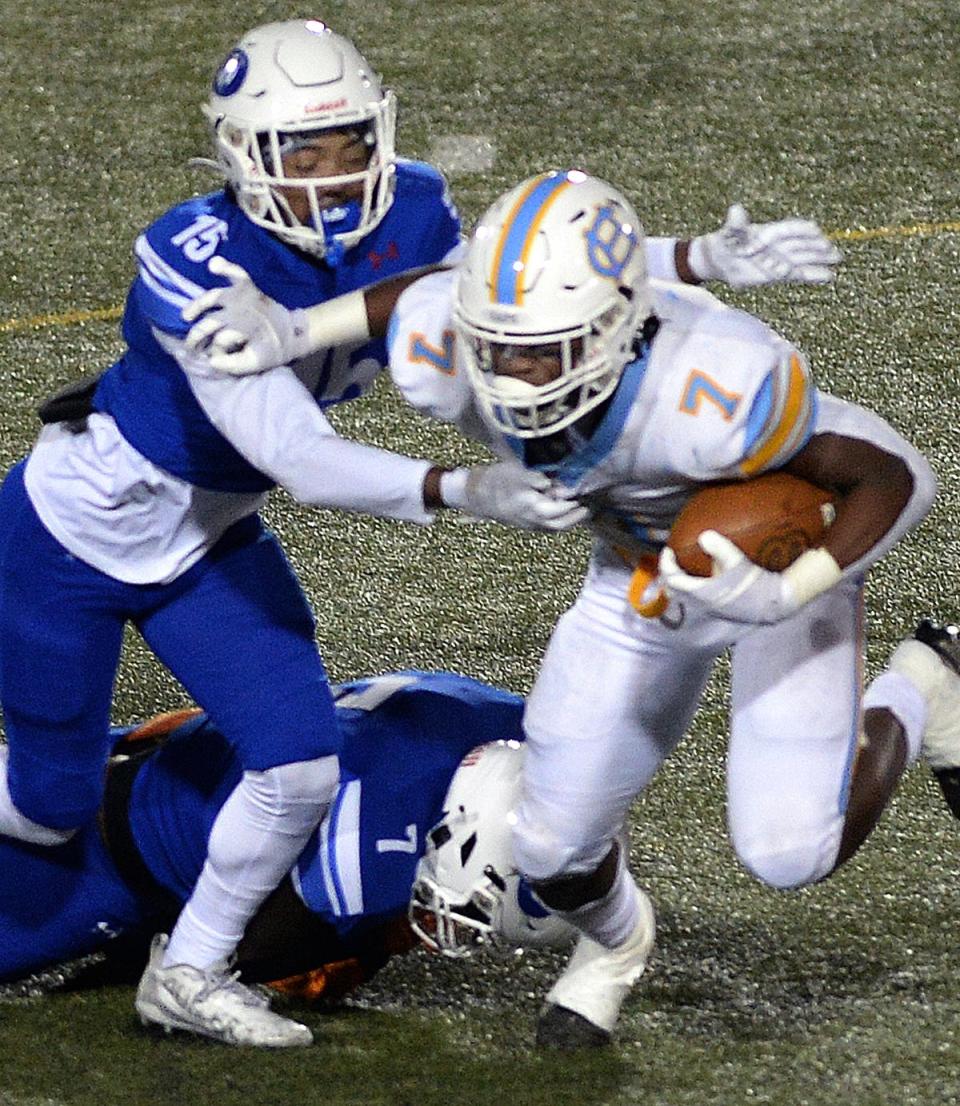 Dover's Ja'Khai Tilghman trying to tackle Maurki James of Cape Henlopen on a first quarter running play.