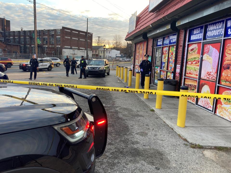 Wilmington Police Department officers investigate a shooting that occurred in front of Ray's Wilmington Market in Wilmington on Sunday, December 5, 2021.