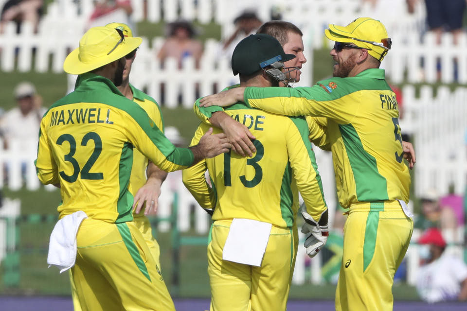 Australia's Adam Zampa , second right, is congratulated by teammates after dismissing South Africa's Dwaine Pretorius during the Cricket Twenty20 World Cup match between South Africa and Australia in Abu Dhabi, UAE, Saturday, Oct. 23, 2021. (AP Photo/Kamran Jebreili)
