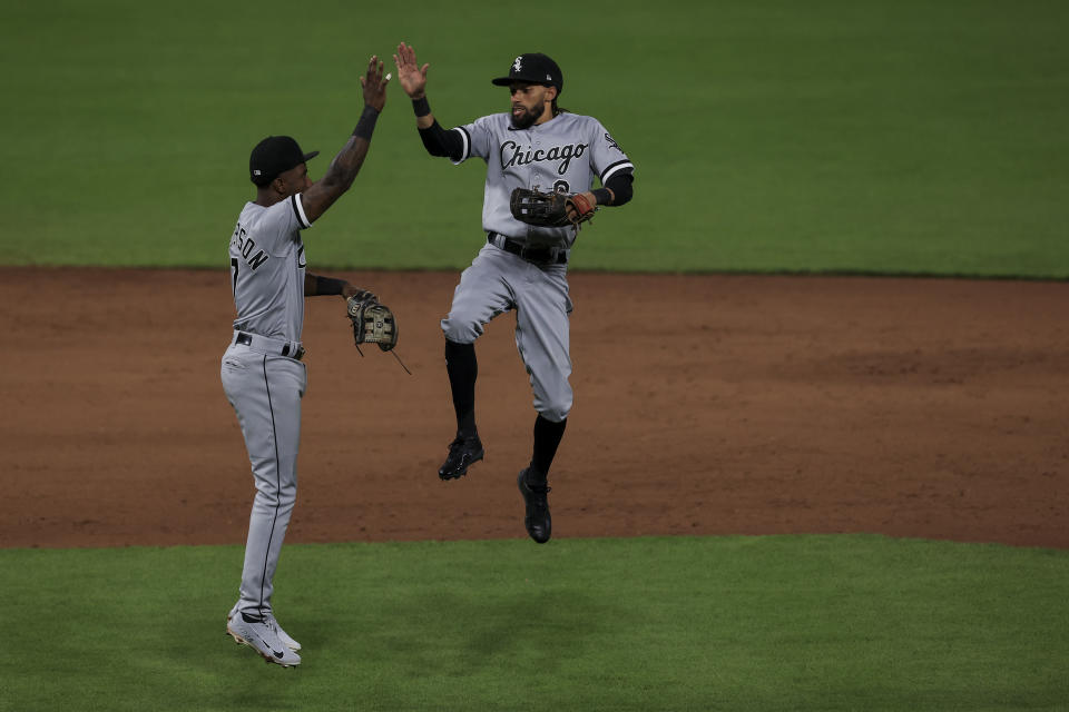 Chicago White Sox Tim Anderson, left, celebrates with Billy Hamilton after the final out of the ninth inning of a baseball game against the Cincinnati Reds, Tuesday, May 4, 2021. (AP Photo/Aaron Doster)