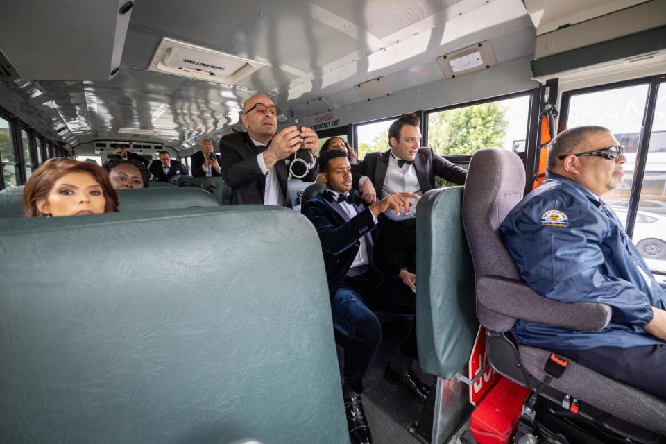 Attendees arrive along with crew on the red carpet in a LAUSD school bus at the Oscars.