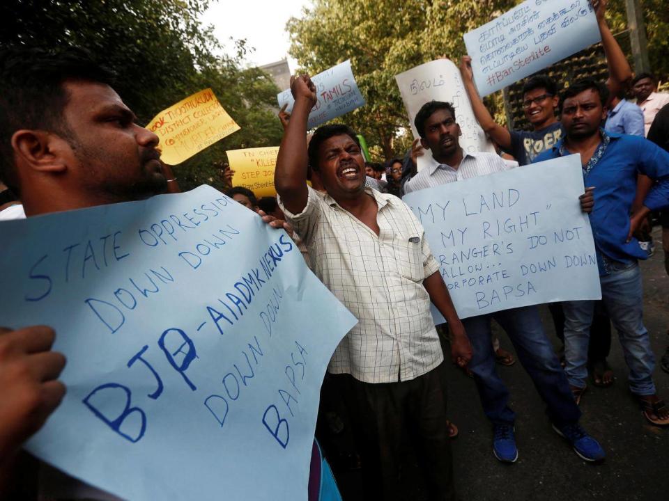 People shout slogans outside Tamil Nadu House during a protest, after at least 11 people were killed when police fired on protesters (ANI via Reuters)