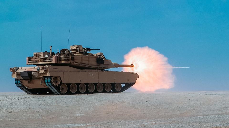 An M1A1 Abrams tank firing on sand during a training exercise in the United Arab Emirates.