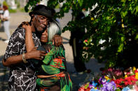 People embrace outside the scene of a shooting at a supermarket a day earlier, in Buffalo, N.Y., Sunday, May 15, 2022. The shooting is the latest example of something that's been part of U.S. history since the beginning: targeted racial violence. (AP Photo/Matt Rourke)