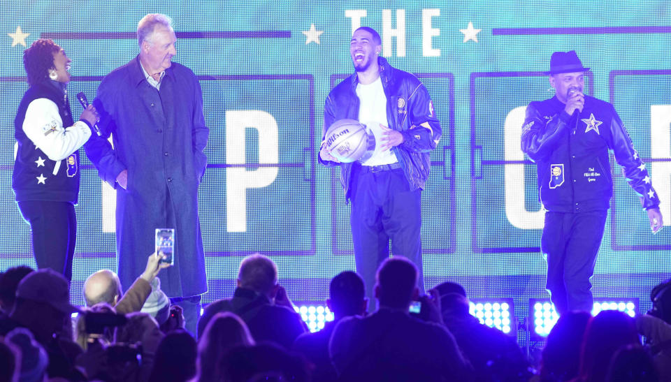 Former Indiana Fever player Tamika Catchings (from left), Larry Bird, Indiana Pacers guard Tyrese Haliburton (0) and Mike Epps talk to a crowd Thursday during the NBA All Star Tip-Off ceremony at the Bicentennial Unity Plaza in downtown Indianapolis.