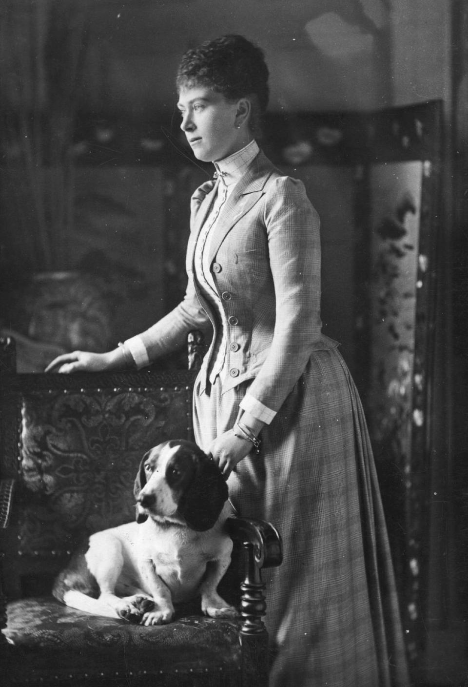 <p>Mary of Teck—the future Queen Mary—was photographed with a dog in the late 19th century. </p>