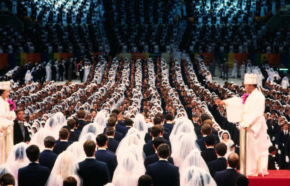 Sun Myung Moon and Hak Ja Han performing a mass wedding for the Unification Church at Madison Square Garden, 1982.