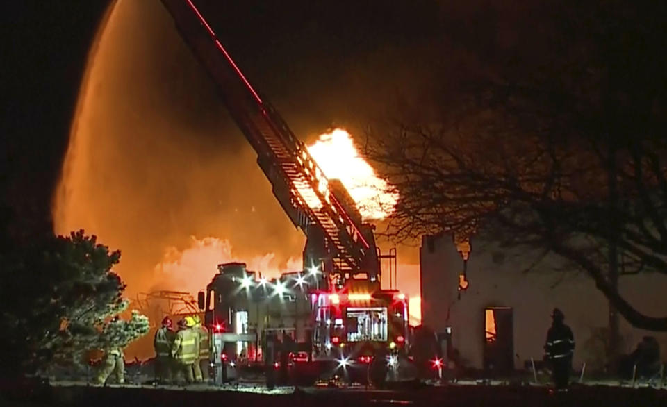 In this frame grab taken from video provided by WXYZ, firefighters battle an industrial fire in the Detroit suburb of Clinton Township, late Monday, March 4, 2024. (Courtesy of WXYZ via AP)