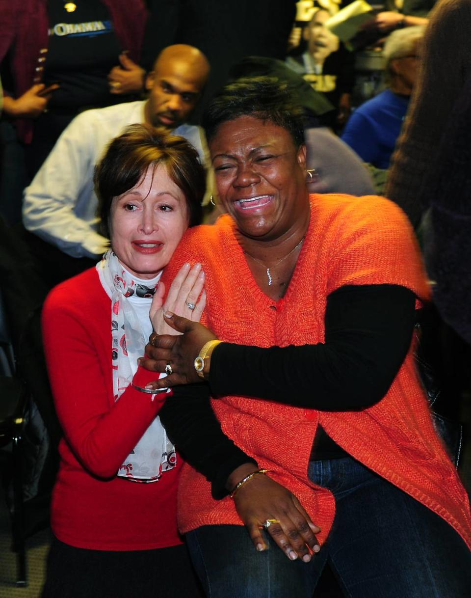 Kim Austin and and Gilda Mack-Benton, right, share tears of joy Jan. 20, 2009, at Excelsior Club in Charlotte watching the historic inauguration of President Barack Obama.