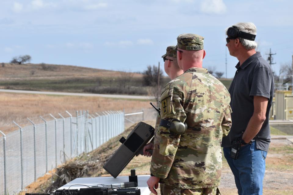 Two Wisconsin National Guardsmen identify drones with their instructor at Fort Sill.